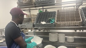 Matthew, a Haitian migrant, washes dishes as a full-time employee at UMass Amherst after receiving his federal work authorization.