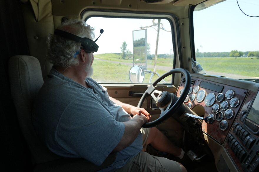 Robert Stobaugh, a rice farmer, looks out at his farm from his big rig.