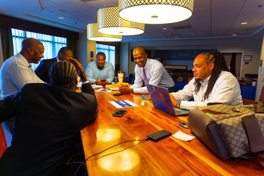 Andrew Brown Jr.'s legal team, along with Bakari Sellers and Rev. Greg Drumwright from Greensboro (right), share a moment of laughter amid a very long series of days.