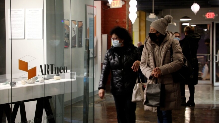 Visitors wander past ARTneo space inside 78th Street Studios during a recent "Third Friday" open house event.