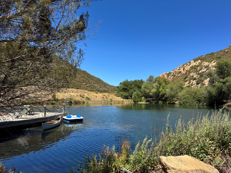 A small pond with a few boats in the water.