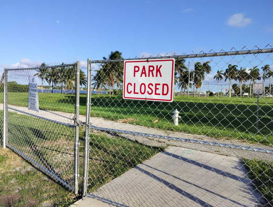A locked gate marks the entrance to Currie Park at 23rd Street in the north end of West Palm Beach.