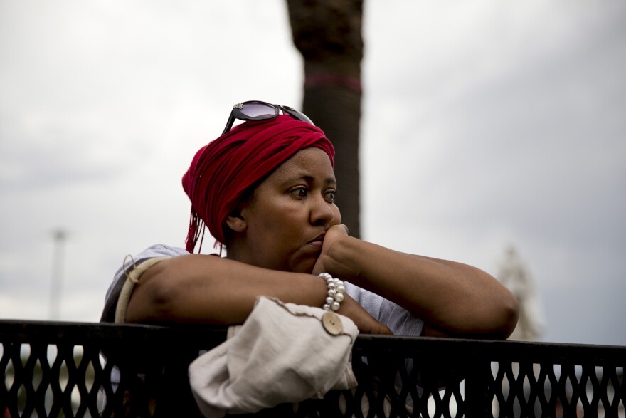 A lady silently mourns. A stark contrast to scenes coming from Johannesburg.