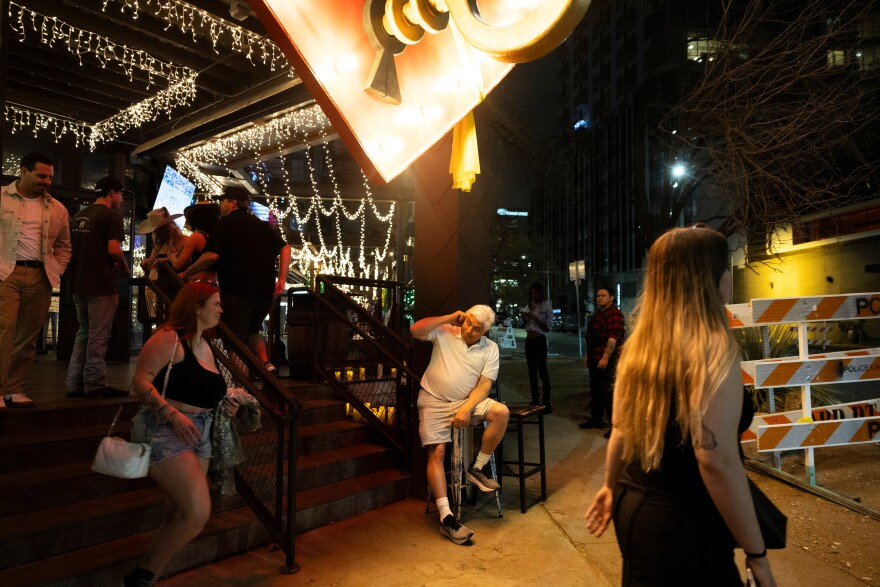 Buford's owner Bob Woody sits outside and greets patrons as they enter the bar Friday.