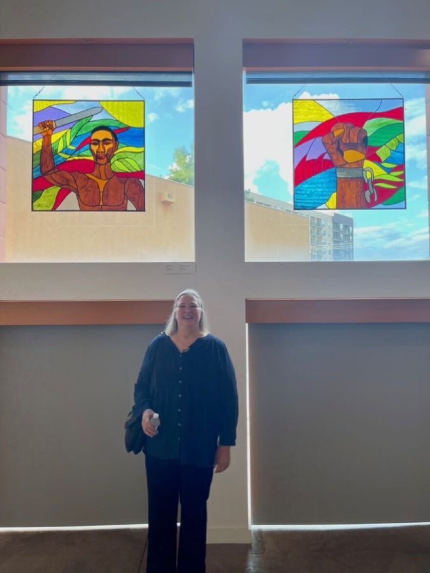 Diane Flynn at the Latino Cultural Center where stained glass pieces she made representing Gaspar Yanga who liberated enslaved people in Mexico and has become a symbol of liberation for Afro-Mexican people.