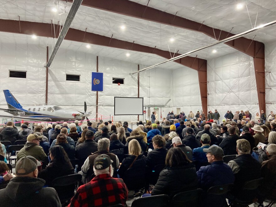 Hundreds of people gathered in an airport hangar to hear about a wind project.