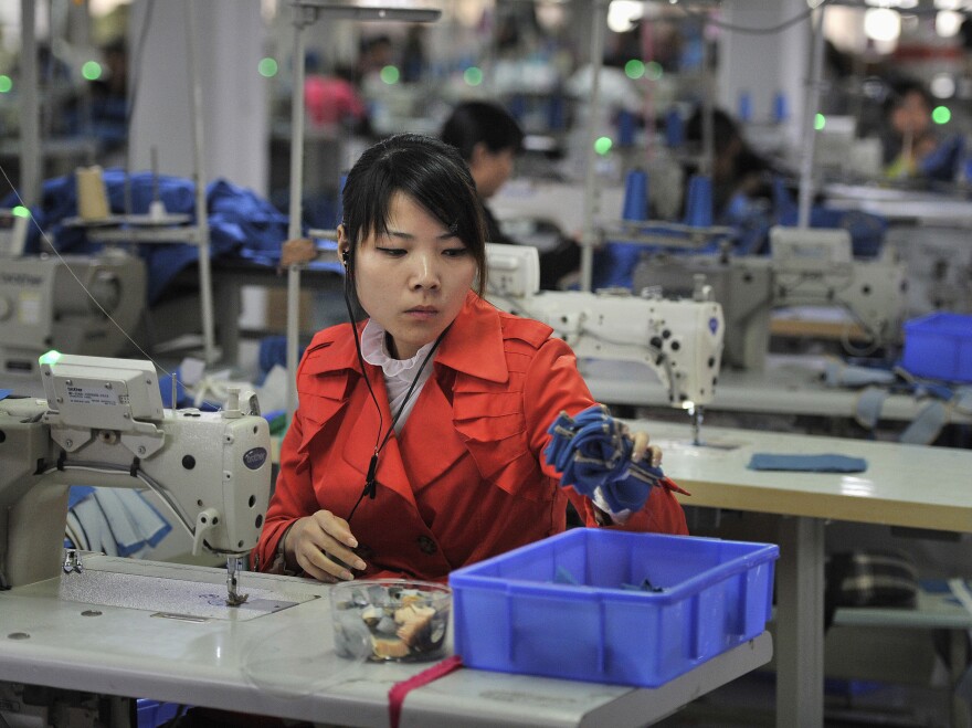 An employee works inside a factory manufacturing clothes for export, in Wuhu, Anhui province, on Nov. 5.