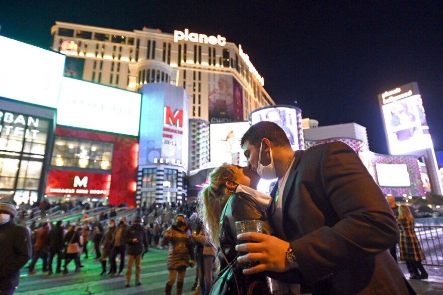 Masked revelers on the Strip ring out 2020, a year that saw the pandemic decimate the Las Vegas tourism industry.