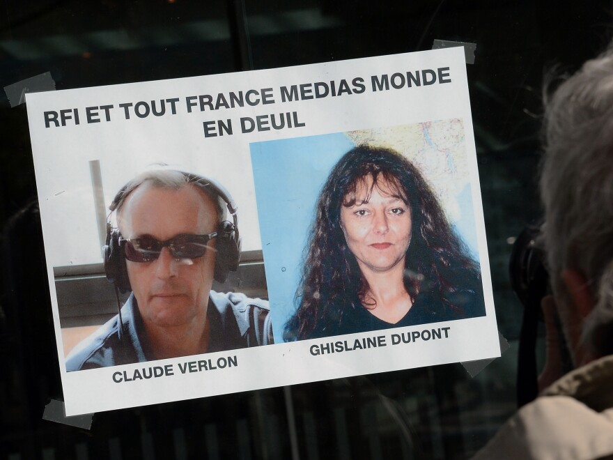 Photos of the two slain journalists in Paris on Sunday.