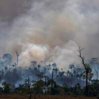 Smoke rises from the fires ravaging the Amazon basin in August. On Monday, Brazilian authorities released data revealing the highest rate of deforestation in the Amazon rainforest in a decade — partly due to a recent surge in wildfires throughout the region.