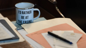 A cup bearing the message “I’d rather be at the casino” sits on the desk of Rep. Charlie Geren, R-Fort Worth, on the Texas House floor on April 6. Geren was a leader in the effort to legalize casinos in Texas.