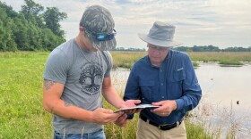 Wildlife Biologist Tom Biebighauser with Hawkins Maki at Round Hill Farm and a wetland