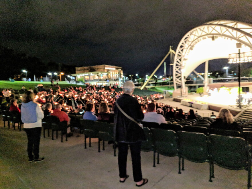 Event participants held candles during the Cascades Park "Hope, Healing, Harmony" memorial.