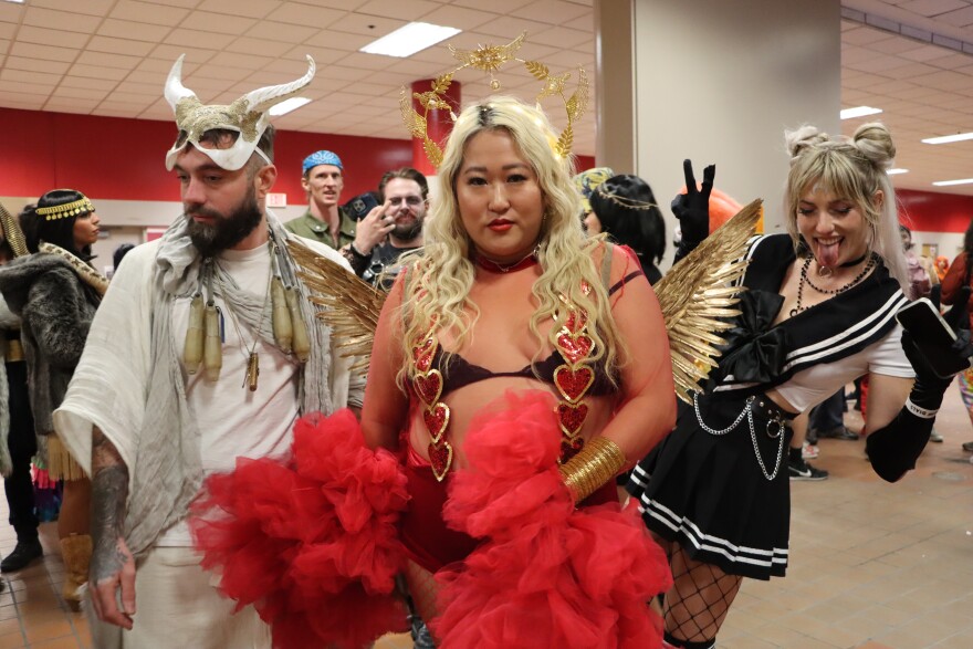 Three attendees in Halloween costumes