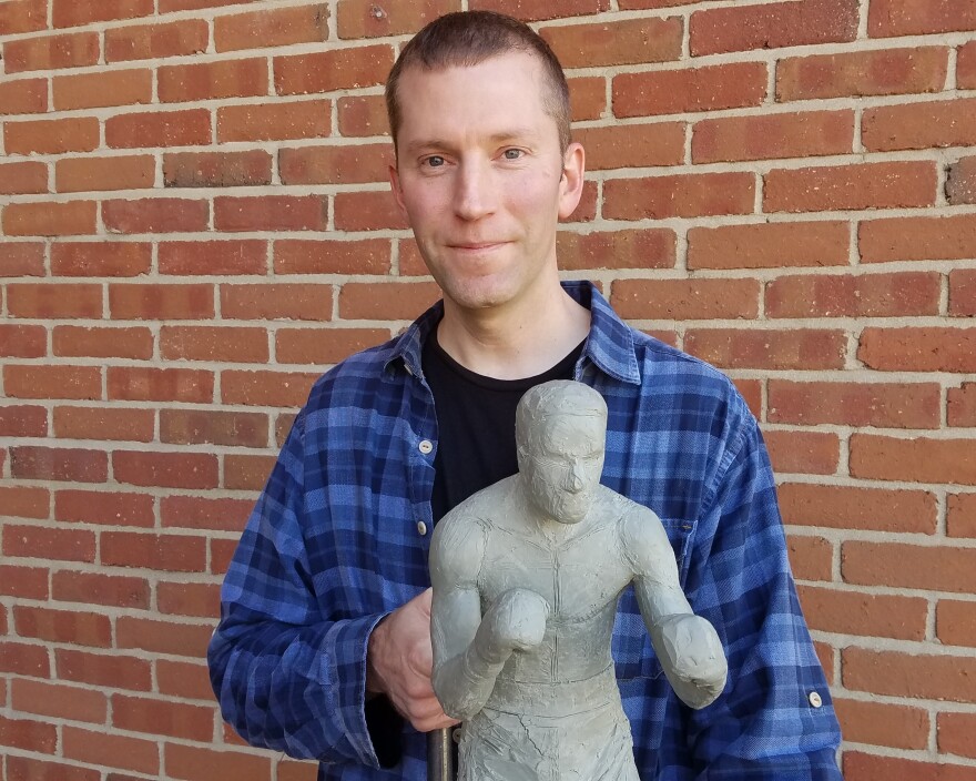 Sculptor John Hebenstreit holds the clay model he'll use to create an eight-foot bronze statue of Ezzard Charles.