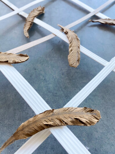 Eryn Pierce submitted her own design for the Scrap to Sculpture Challenge. Her piece, “Birds of a Feather Fall Together,” is a delicate lattice of feathers. In her artist statement she wrote, ” This work serves as both a tribute to these birds and a call to action, encouraging us to rethink how we design and interact with our surroundings to create safer spaces for the natural world.”