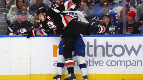 Buffalo center Tage Thompson checks Tampa Bay right wing Pontus Holmberg during the first period of the game in Buffalo on Monday, April 6, 2026. Holmberg left the game with an injury after falling into an open penalty box door later in the game.
