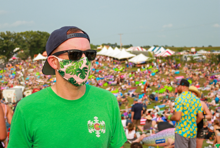 An attendee masks up en route to the hilltop.