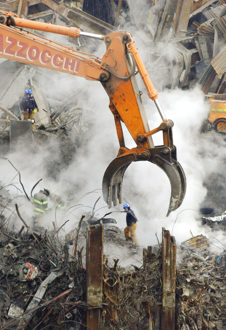 In this Dec. 28, 2001 file photo, emergency workers continue recovery and cleanup efforts with the help of heavy machinery at the site of the World Trade Center attacks in New York.