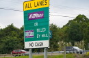 Signs at an entrance ramp inform motorists about toll collection methods on the Pennsylvania Turnpike in this 2021 file photo.