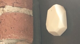 This Bluetooth beacon, displayed in Marquett Burton's office, is an example of what colleges and universities would put on their classroom walls. It can be set to a range of one foot to 150 meters.