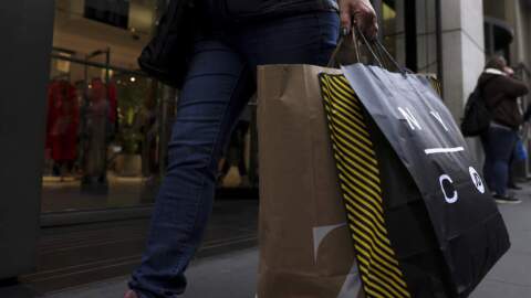 A shopper carries bags down Fifth Avenue in New York. (Julia Nikhinson/AP)