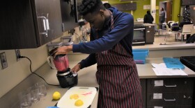 A student in a nutrition class makes a smoothie for a class assignment.