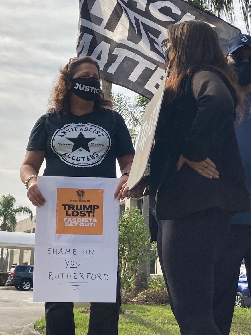 Mary Ann Cordray of St. Augustine was among those protesting outside of Rep. John Rutherford's Jacksonville office Thursday.