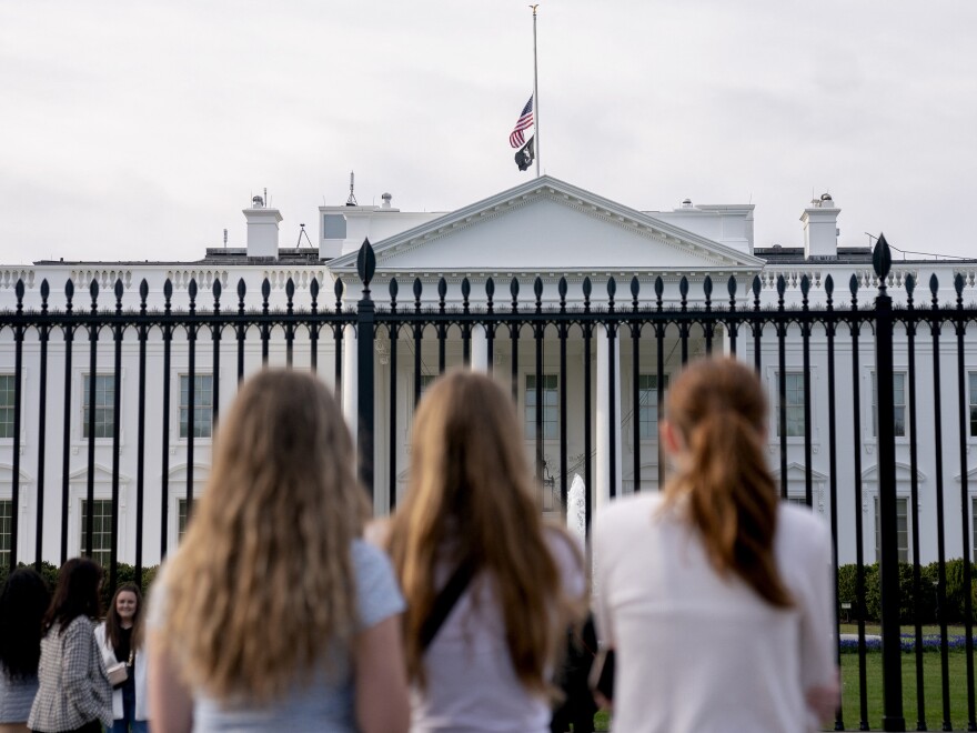 Visitors look upon the White House as the US flag flies at half mast following a school shooting in Nashville, Tennessee last March.