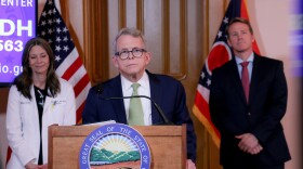 Gov. Mike DeWine at his daily coronavirus update on March 20, flanked by Ohio Department of Health Dr. Amy Acton and Lt. Gov. Jon Husted.