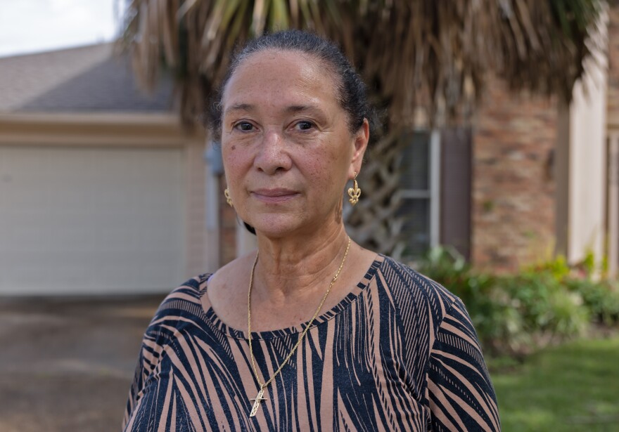 East New Orleans Neighborhood Advisory Commission President Dawn Hebert poses in front of her house.