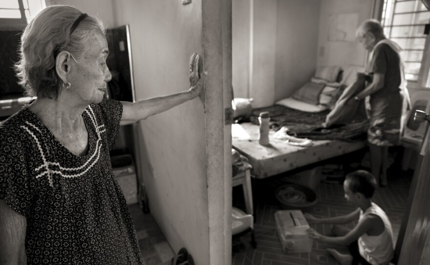 Narcisa Claveria, watches husband, Anaceto, and their great-grandson as he wakes up from a nap. At age 12, Narcisa was dragged from her home by Japanese soldiers and forced to serve as a sex slave in a garrison for 1 1/2 years. At a time when the experience was seen as a mark of shame, her husband encouraged her to share her story and told her: "I am not repulsed by you."