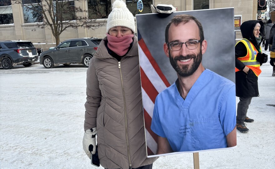 A protestor holds a sign of 37-year-old nurse Alex Pretti, who was killed in Minneapolis over the weekend. (Photo: Maxwell Howard/IPR News)