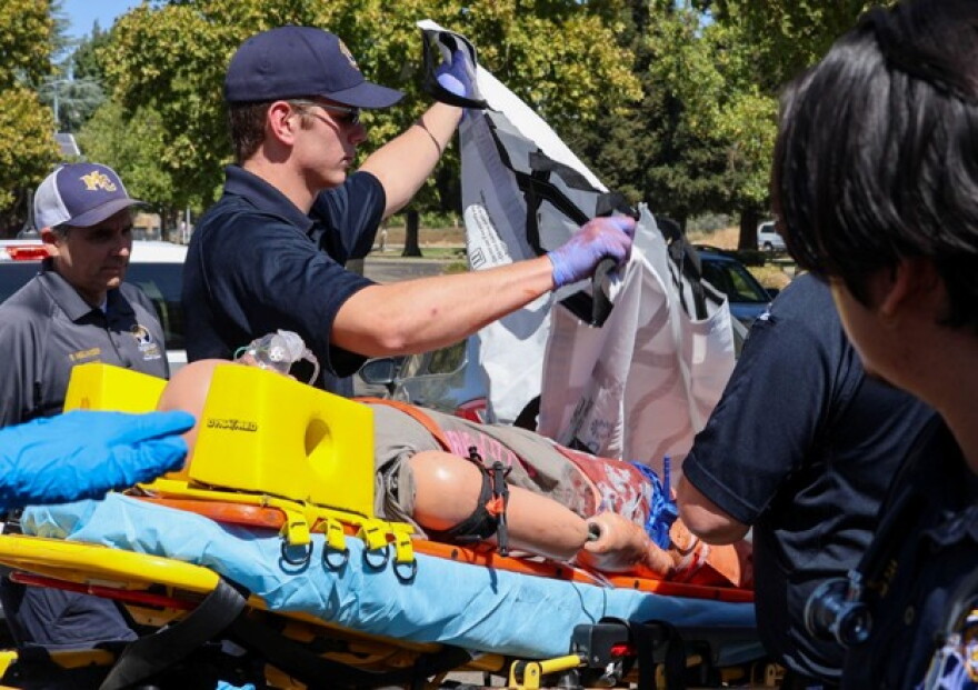 After transporting the patient from the field, students practice moving the dummy to an ambulance and the hospital.