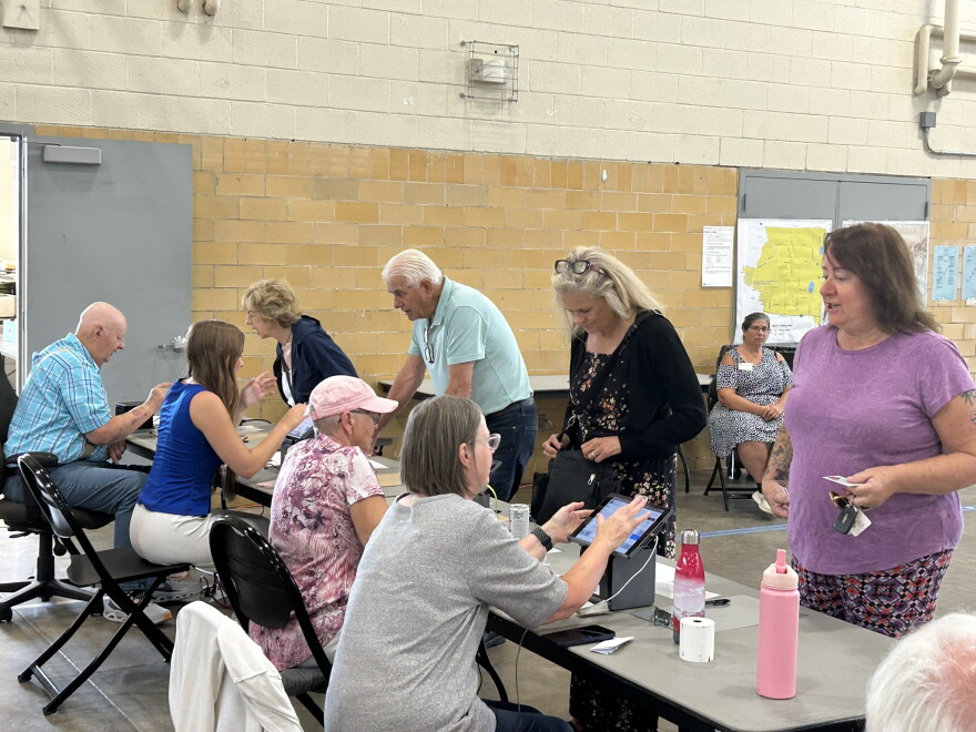 Election judges check voters in Aug. 11, 2026, in Hibbing. City Clerk Candie Seppala says between 48 and 50 volunteers are required to work the city's polls each election. The midterm primary volunteers included eight newcomers.