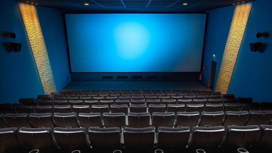 Empty movie theater with blank screen