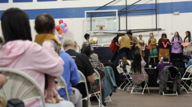 Community members watch a traditional dance performed by Ida’ina K’eljeshna, Friendship Dancers, at the Indigenous Peoples Day event at the Moseley Sports Center in Anchorage, Monday, Oct. 12, 2026.