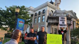 Protesters gather by the Confederate monument on county courthouse grounds