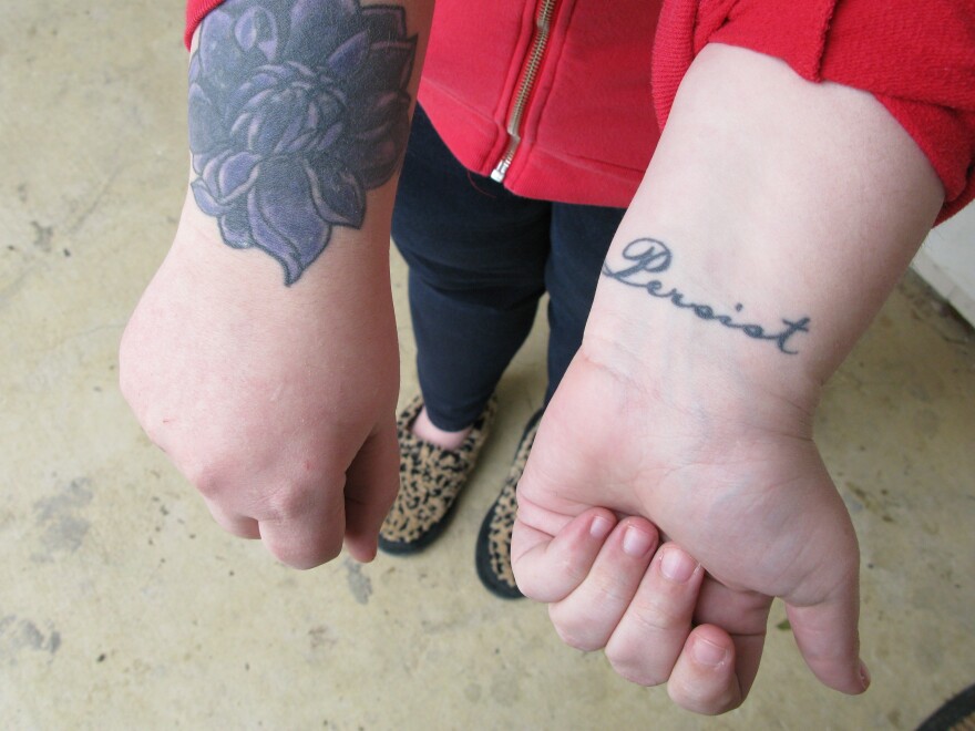 This woman, who has had her prostitution charge wiped away, says she got the lotus tattoo to cover up the brand of a former pimp. "Once they put their name on me, I was their property," she adds. She says she got the word "persist" tattooed as a reminder to keep moving forward.