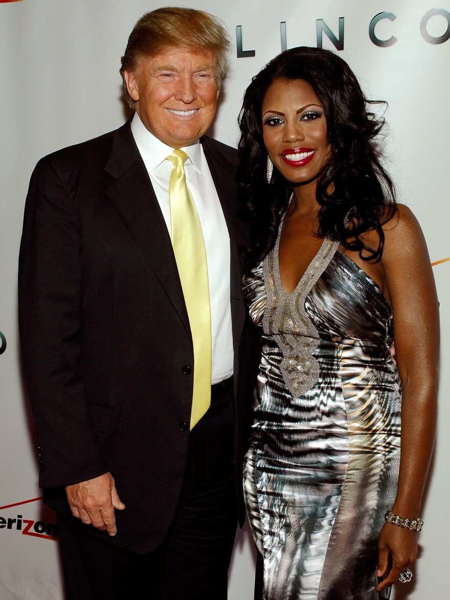 Donald Trump and Omarosa Manigault attend <em>The Ultimate Merger</em> premiere at Trump Tower in 2010. Manigault appeared on the first season of <em>The Apprentice</em> and made later appearances on other Trump reality shows.