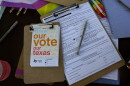 Voter registration applications are seen at the Texas Rising tent during a Pride celebration in Corpus Christi, Texas, on Oct. 5, 2024.