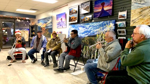 Delbert Anderson leads musicians in performing a single note, as part of a 4.5 year long performance of a composition called "The Long Walk."