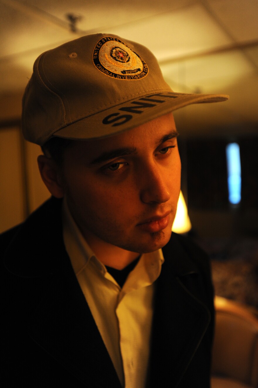 Adrian Lamo in a motel room on Long Island, N.Y. Lamo tried to make light of his reputation as a snitch, even wearing a hat that labeled him as such.