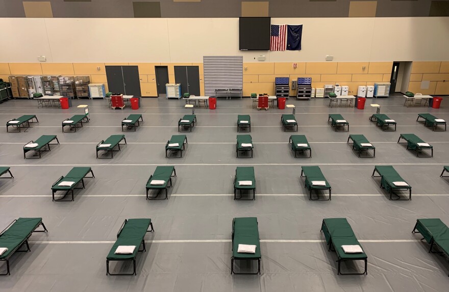 An open gym with cots on the floor