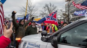 Trump supporters push back a police car while gathering outside the Capitol Building. (Probal Rashid/LightRocket via Getty Images)