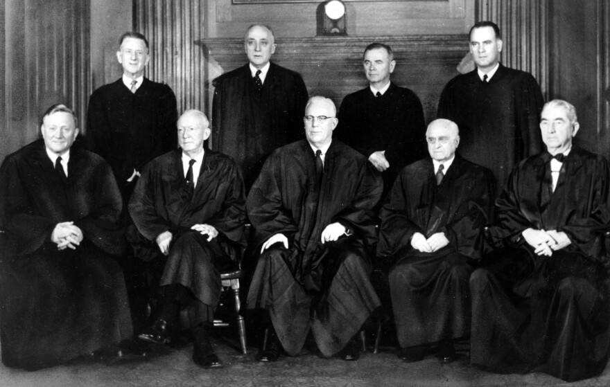 Justices of the U.S. Supreme Court pose for a portrait in their robes in Washington in 1958. Standing at left is Justice Charles Whittaker, who resigned from the court after having a nervous breakdown.