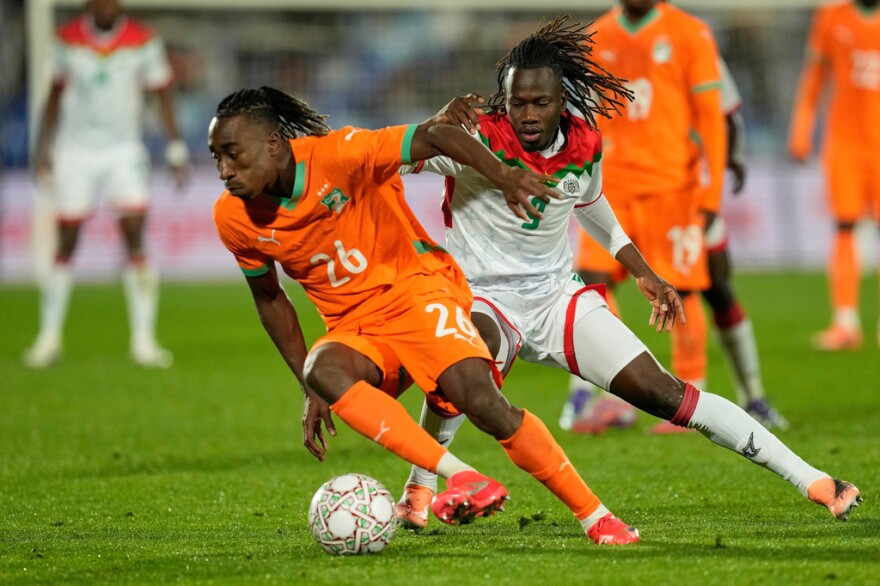 FILE - Ivory Coast's Yan Diomande, left, and Burkina Faso's Issa Kabore challenge during the Africa Cup of Nations best of 16 soccer match between Ivory Coast and Burkina Faso in Marrakech, Morocco, on Jan. 6, 2026. (AP Photo/Themba Hadebe, File)
