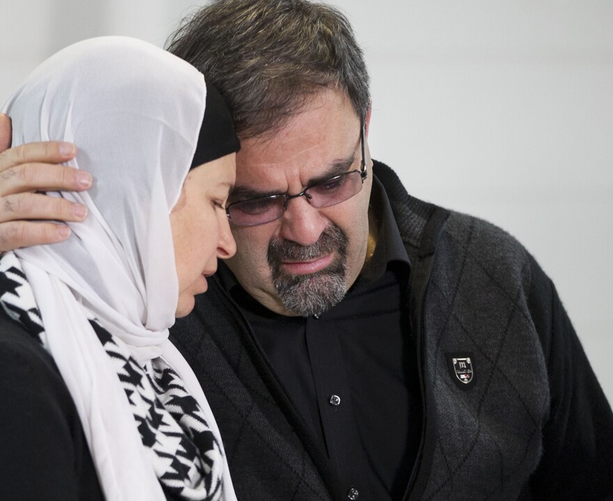 Namee Barakat embraces his wife Layla Barakat during a news conference at the Swift Creek Exchange Club on Wednesday, in Raleigh, N.C.