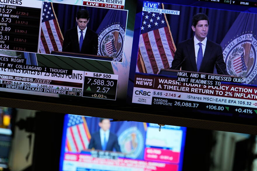 Screens display a news conference held by Federal Reserve chairman Kevin Warsh on the floor of the New York Stock Exchange in New York, Wednesday, Sept. 16, 2026.