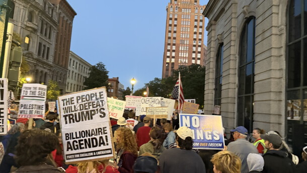 Protestors march through Syracuse holding signs